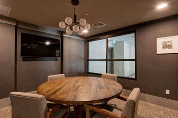a dining room with a table and chairs and a television